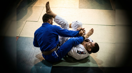Two grapplers in gis mid-match on competition mats - jiu-jitsu news